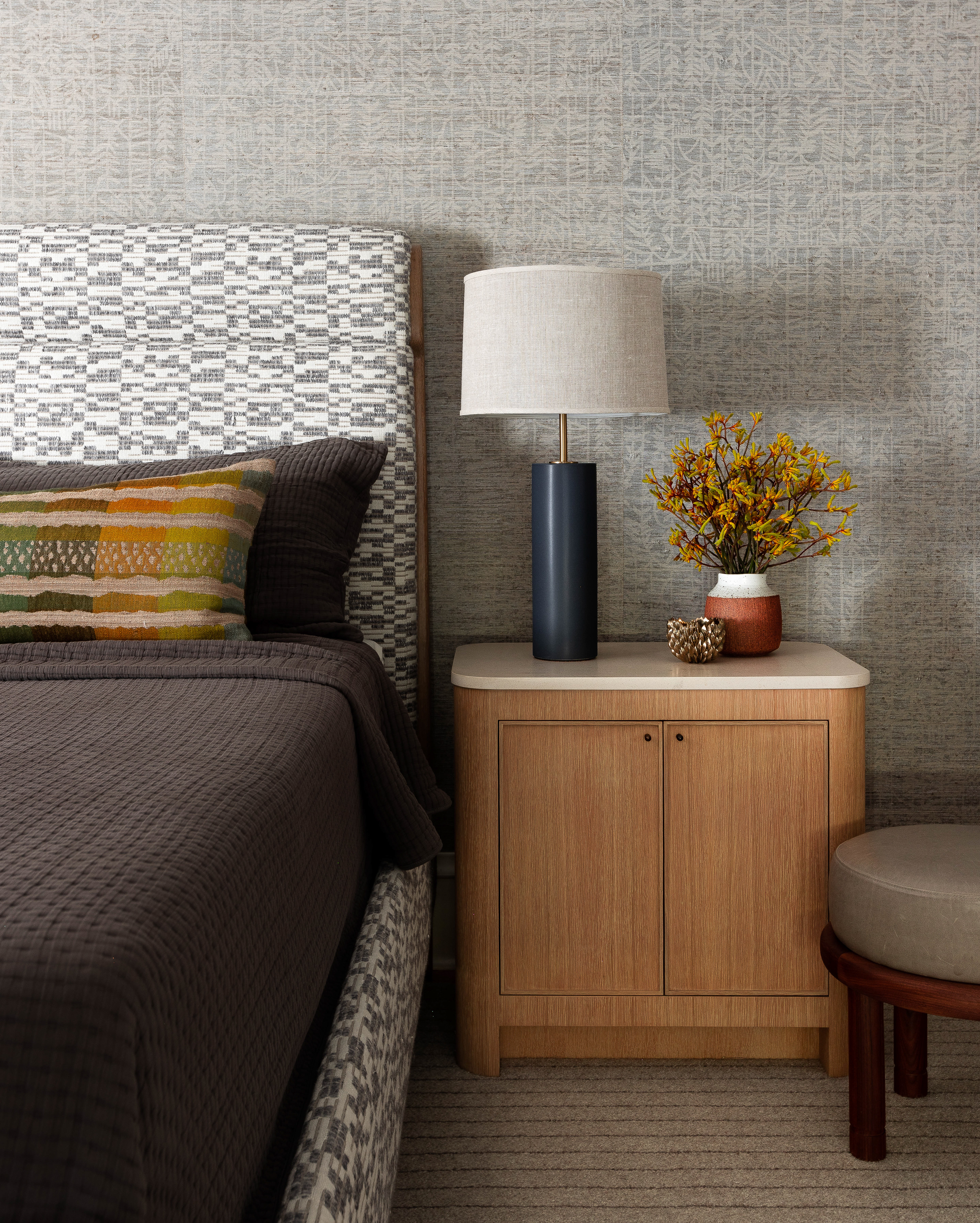 A tribal Mark Alexander Wall Paper meets Pat McGann Fabric in this textile rich bedroom.