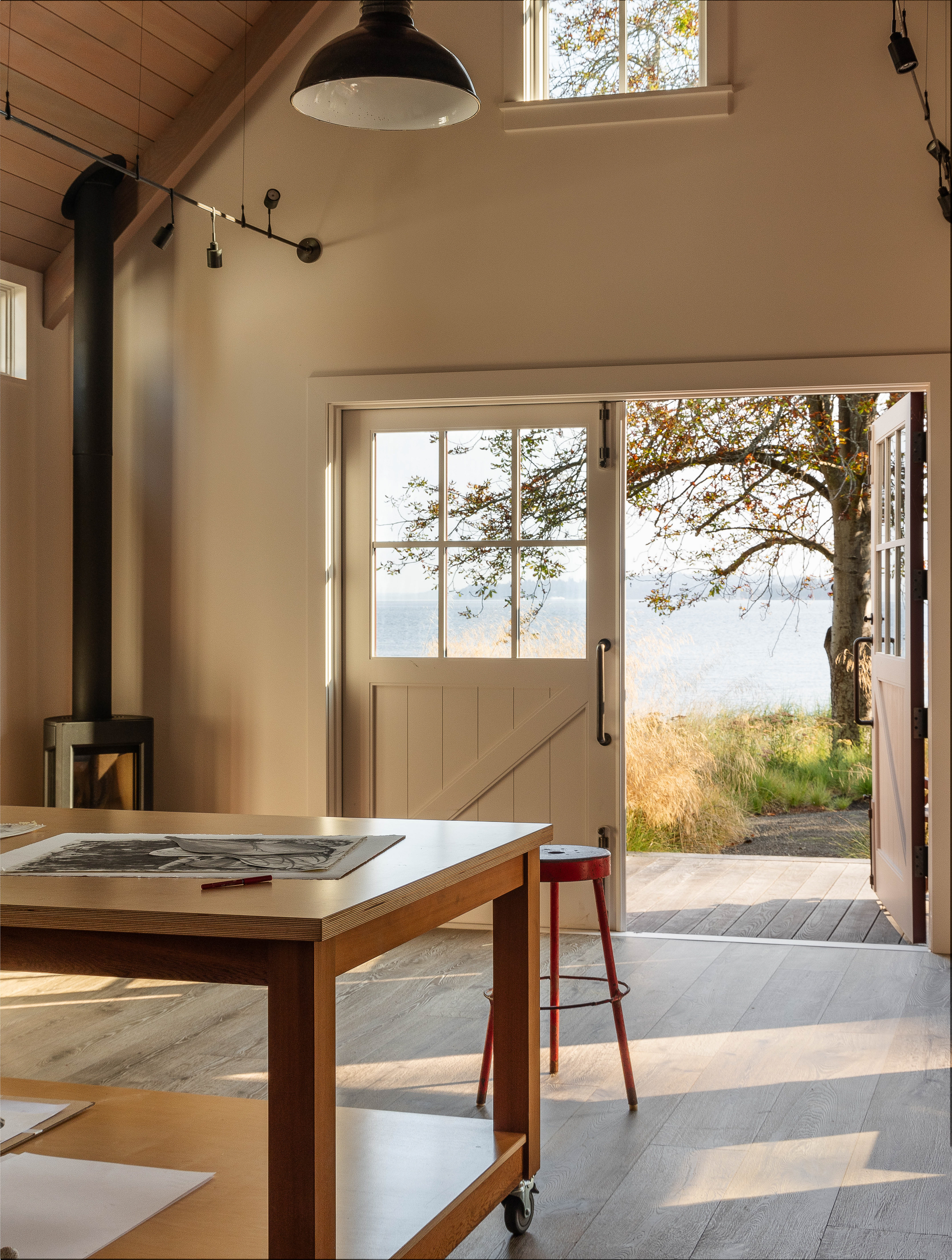 Interior of the Studio building featuring a versatile rolling studio table, designed for easy mobility between indoor workspaces and the outdoors.