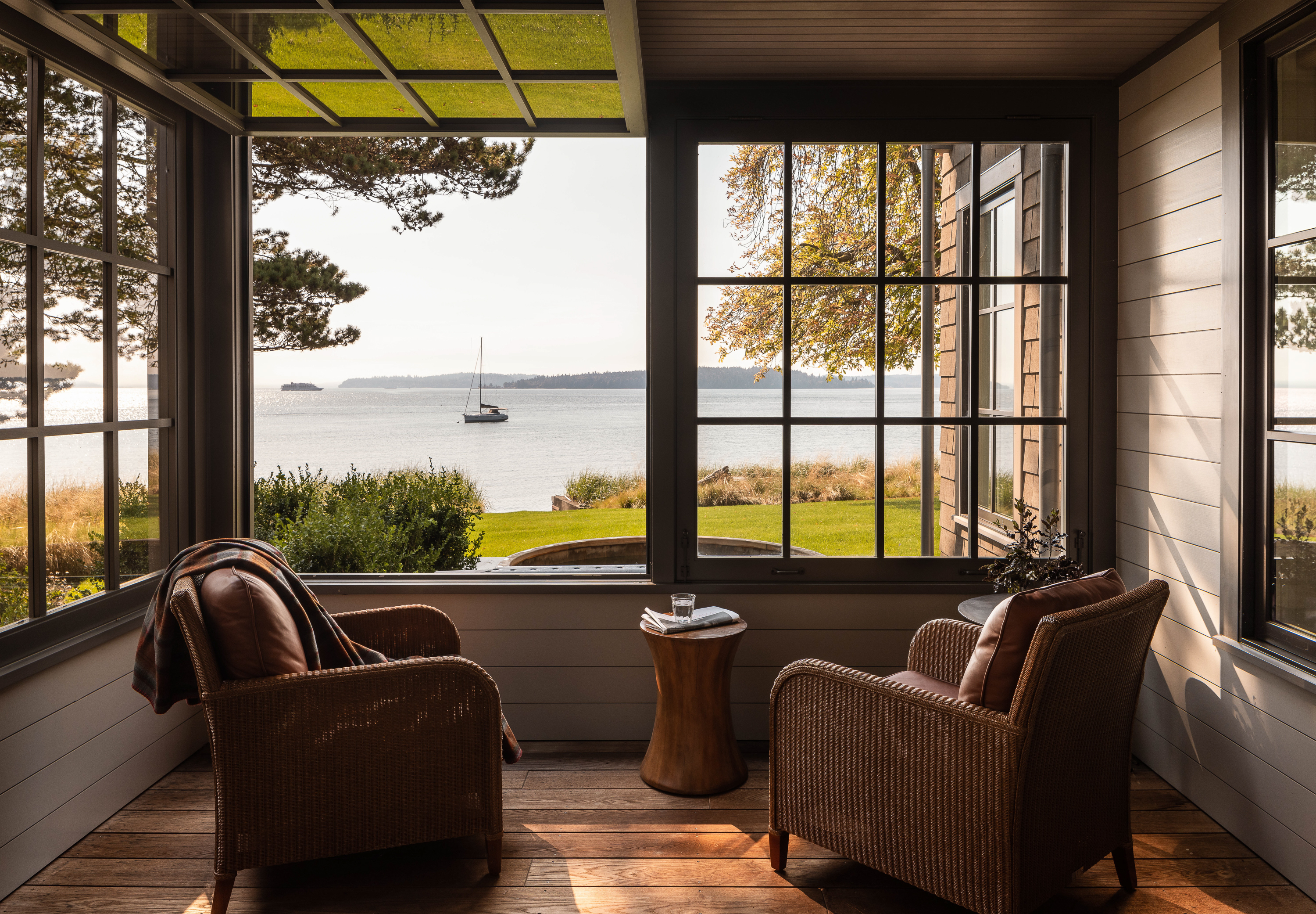 The covered porch, an extension of the family room, features hinged window that open fully, creating an indoor-outdoor sanctuary.