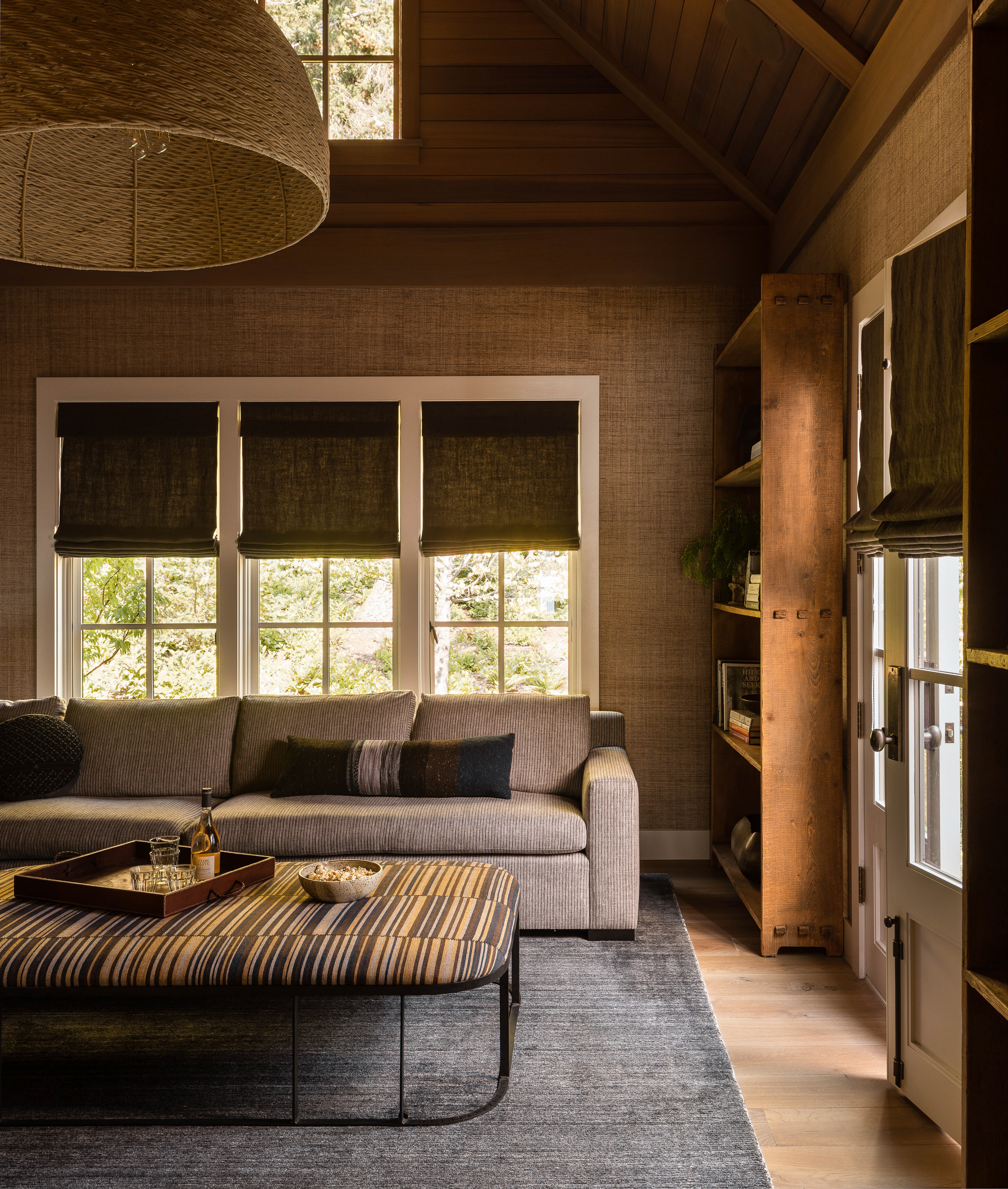 The family room is designed to be cozy and moody, perfect for watching movies and creating a relaxed atmosphere.