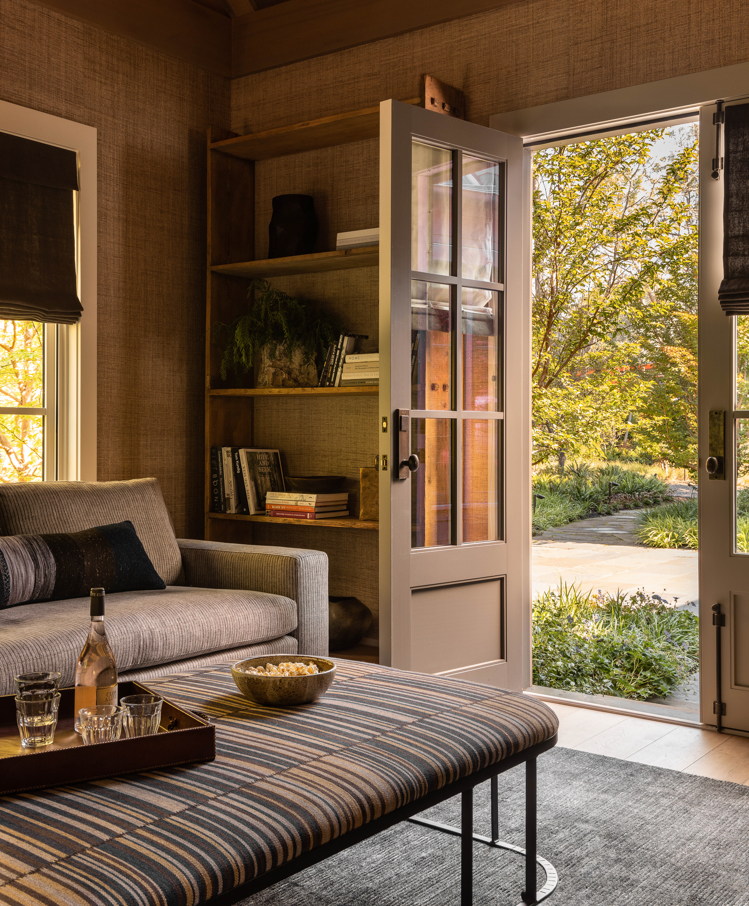 A movie room with a view onto the front patio, offering both entertainment and a connection to the outdoor space for a well-rounded experience.