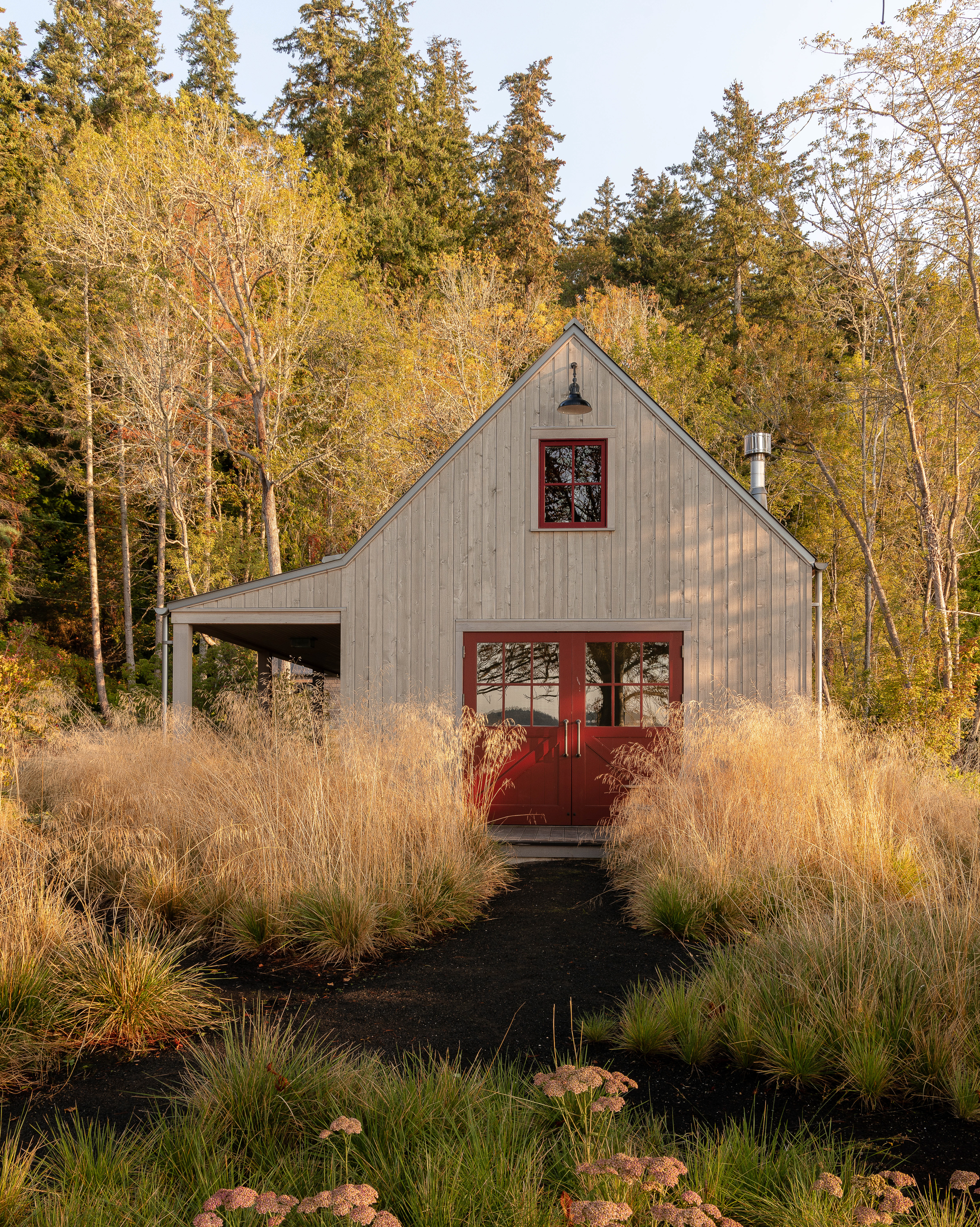 Exterior view of the studio building, characterized by its simple yet iconic silhouette and striking red doors.